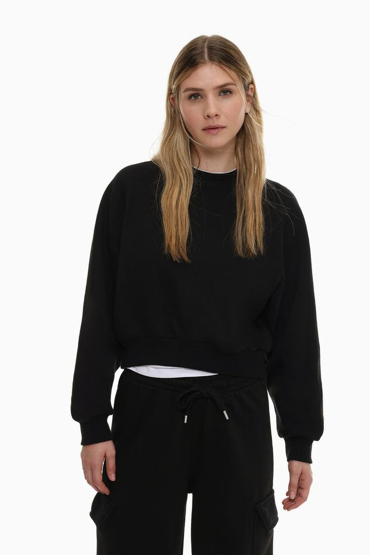 Women's black basic cropped sweatshirt, offering a simple, stylish design with a relaxed fit, perfect for casual wear.