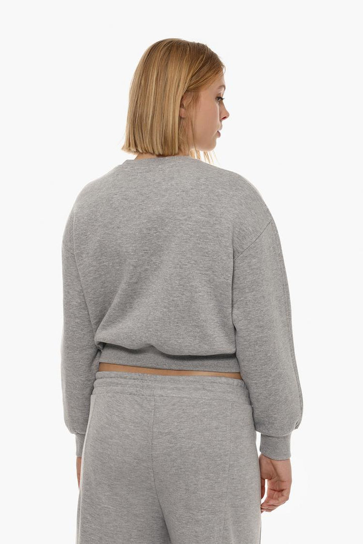 Back view of a women's grey basic cropped sweatshirt, highlighting the relaxed fit, cropped length, and simple design.