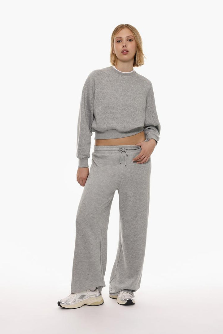 Zoomed-out view of the body of a women's grey basic cropped sweatshirt, highlighting the full design, including the relaxed fit and cropped length.