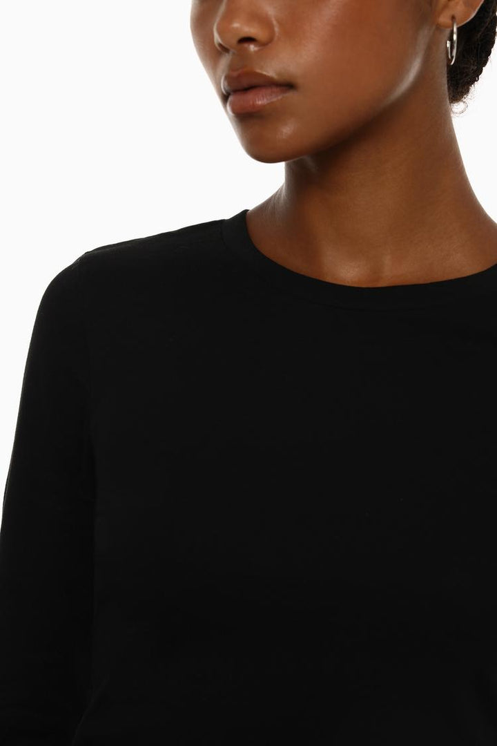 Body view of the black cropped long-sleeve top, highlighting its streamlined design with long sleeves and a flattering cropped fit for a stylish, casual look.