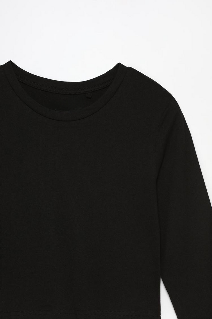 Product view of the black cropped long-sleeve top, featuring a sleek and minimalist design with long sleeves and a cropped fit, making it a versatile addition to any wardrobe.