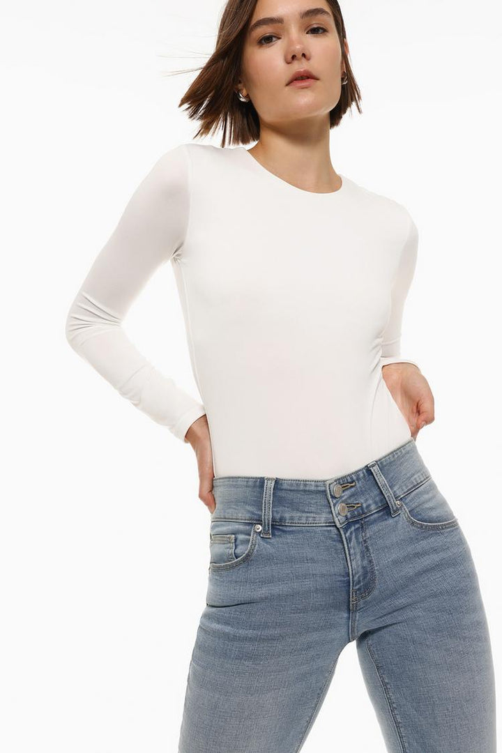 Body view of the white polyamide round neck bodysuit, showcasing the smooth, stretchy fabric and flattering fit that contours to the body for a sleek and polished look.