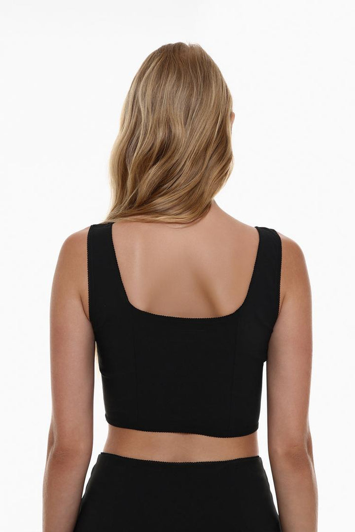 Back view of the black rustic strappy top with a bow, showcasing the delicate straps and the playful bow detail, offering a chic and feminine look from every angle.