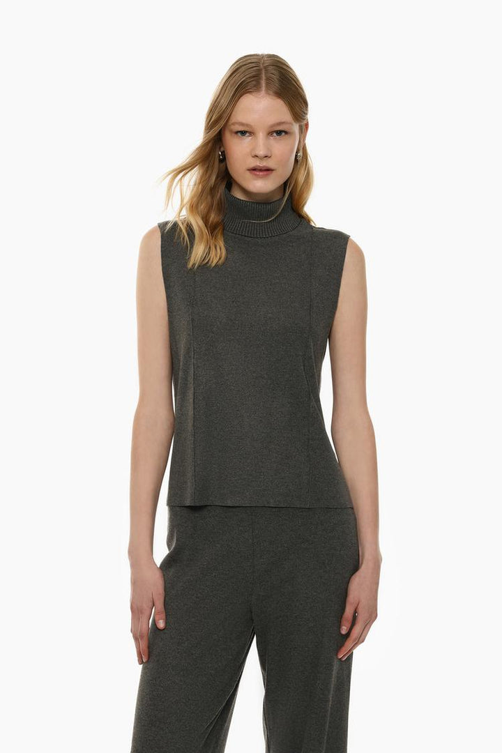 Grey soft-touch vest sweater, crafted from a smooth, cozy fabric that offers a comfortable fit. Its minimalist design makes it a versatile piece for layering or wearing on its own for a relaxed, stylish look.