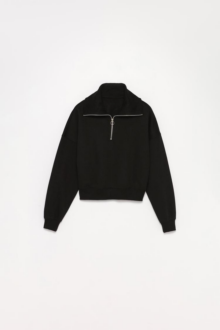 Women's black sweatshirt with a zip-up collar, offering a stylish and comfortable fit, perfect for layering and casual wear.