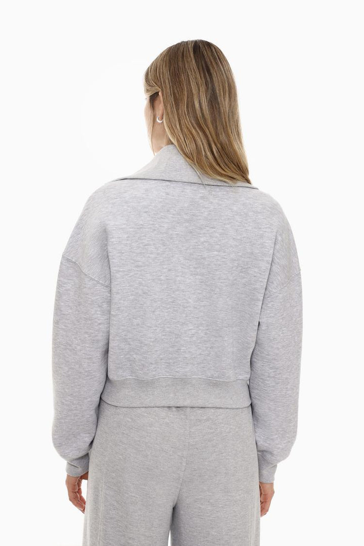 Back view of a women's grey sweatshirt with a zip-up collar, featuring a simple and clean design with a comfortable fit.