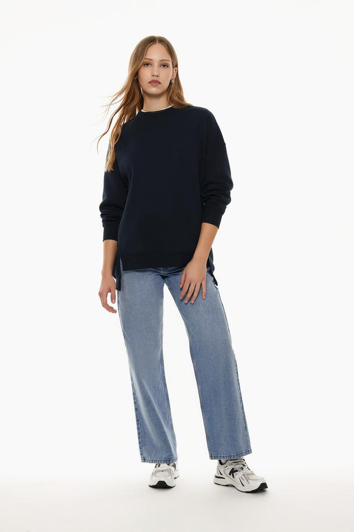 Full-body view of a women's navy blue oversized sweatshirt with an asymmetric design, styled for a casual and trendy look.