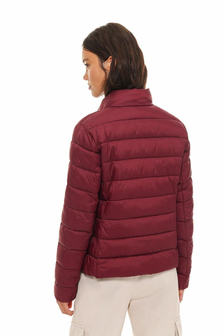 Back view of a basic lightweight puffer jacket in vibrant red, highlighting its sleek design and smooth finish.