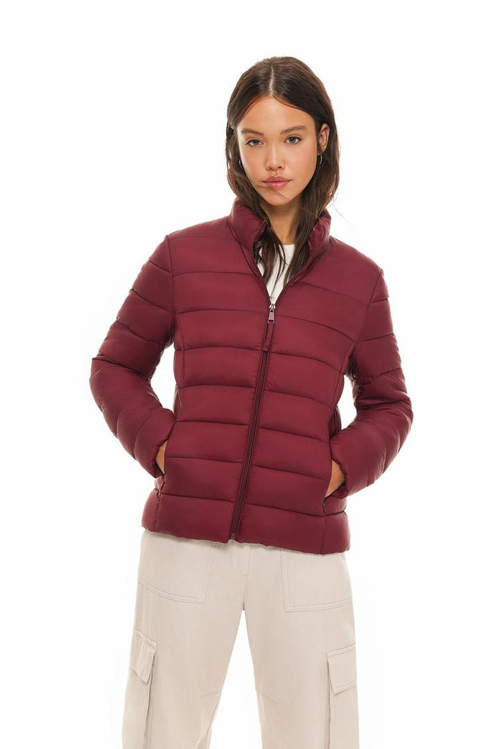 Women's basic lightweight puffer jacket with a sleek and modern design, perfect for casual wear and outdoor activities. Lightweight, warm, and ideal for layering in cooler weather.