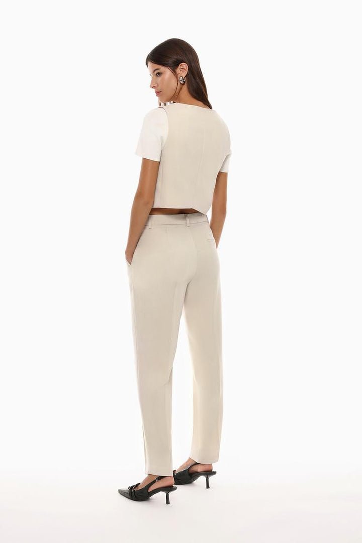 Back view of beige basic smart trousers, featuring well-defined seams and tailored fit