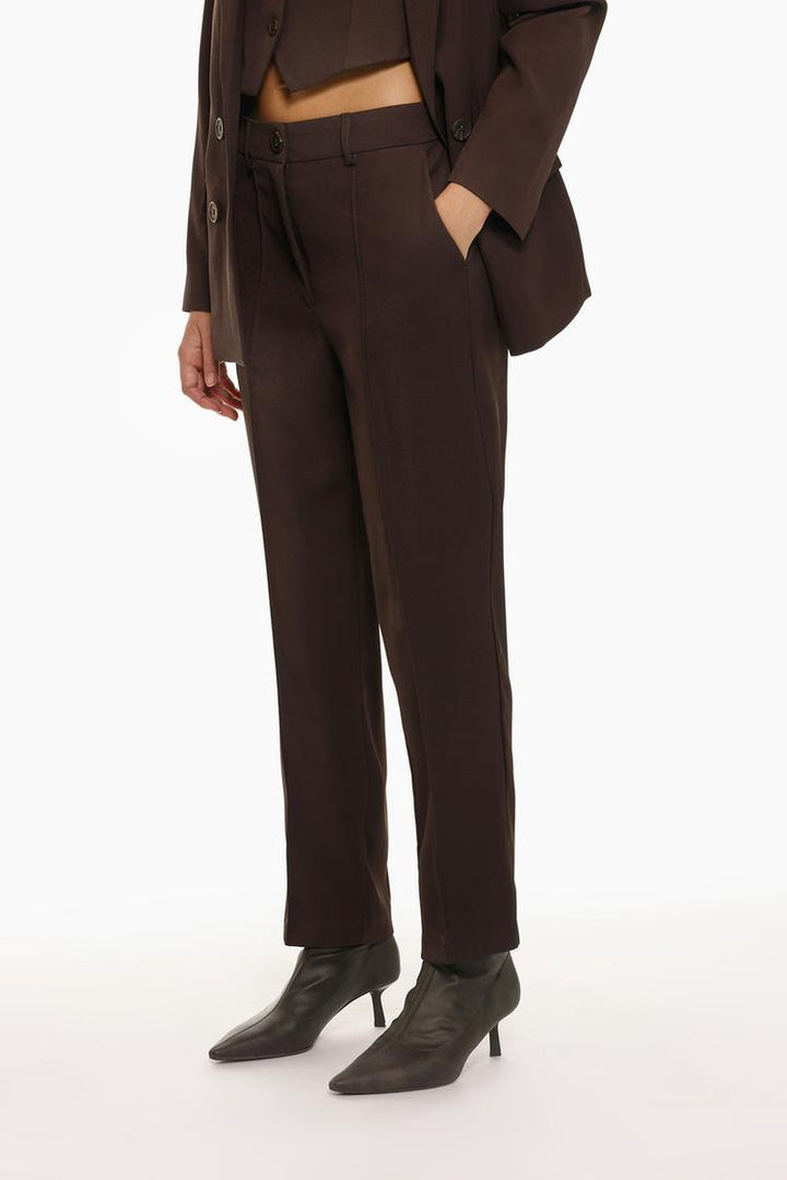 Front view of brown basic smart trousers, showcasing a sophisticated and stylish cut