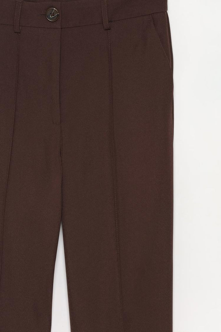 Back view of brown basic smart trousers, showing attention to design and fit