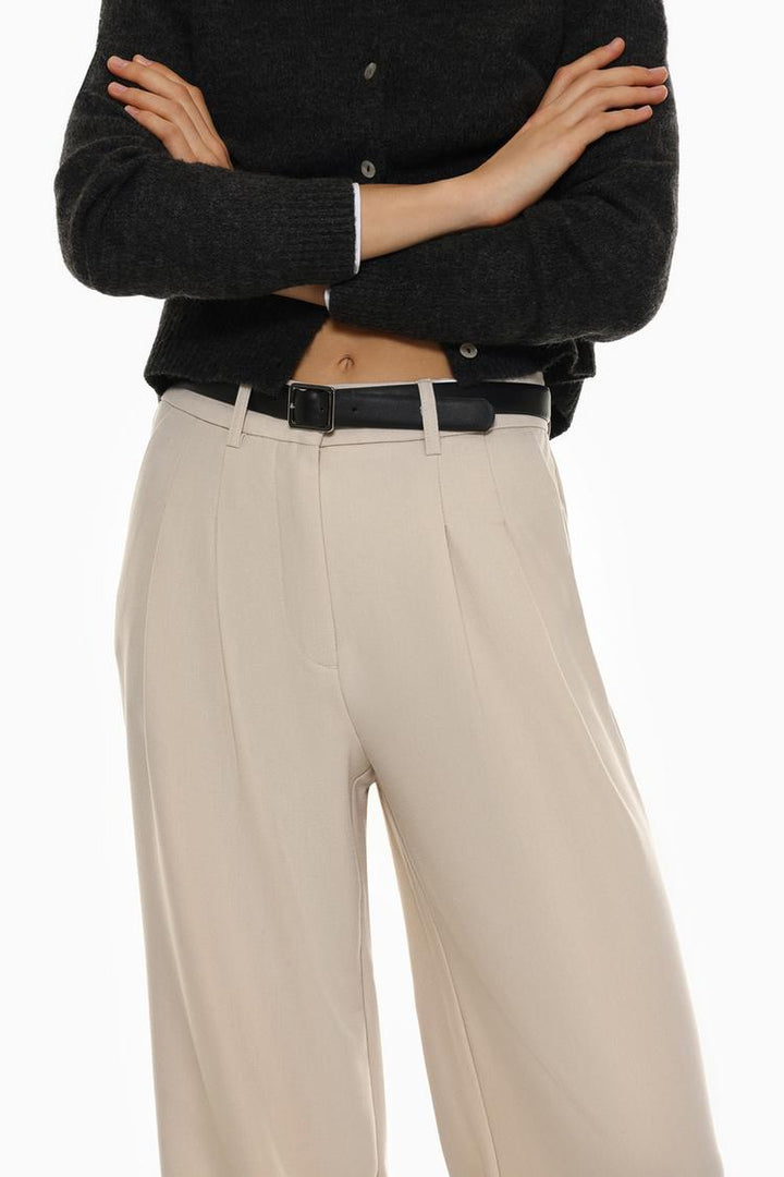 Body view of beige belted wide-leg trousers, highlighting a relaxed yet polished fit