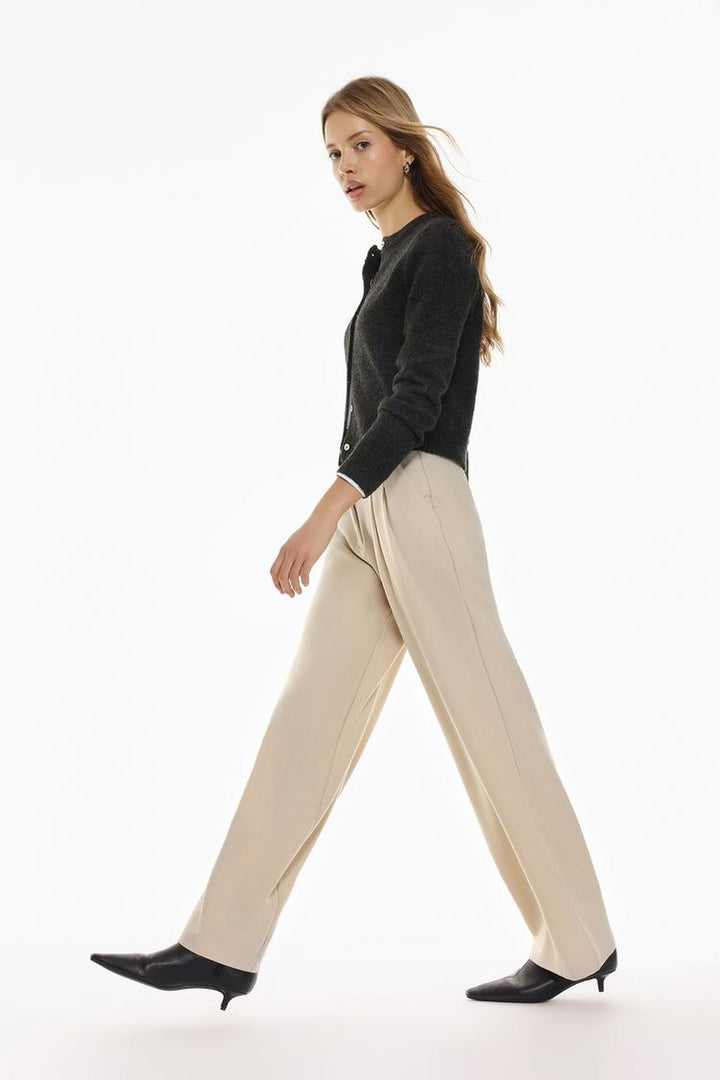 Side profile of beige belted wide-leg trousers, offering a refined and contemporary look