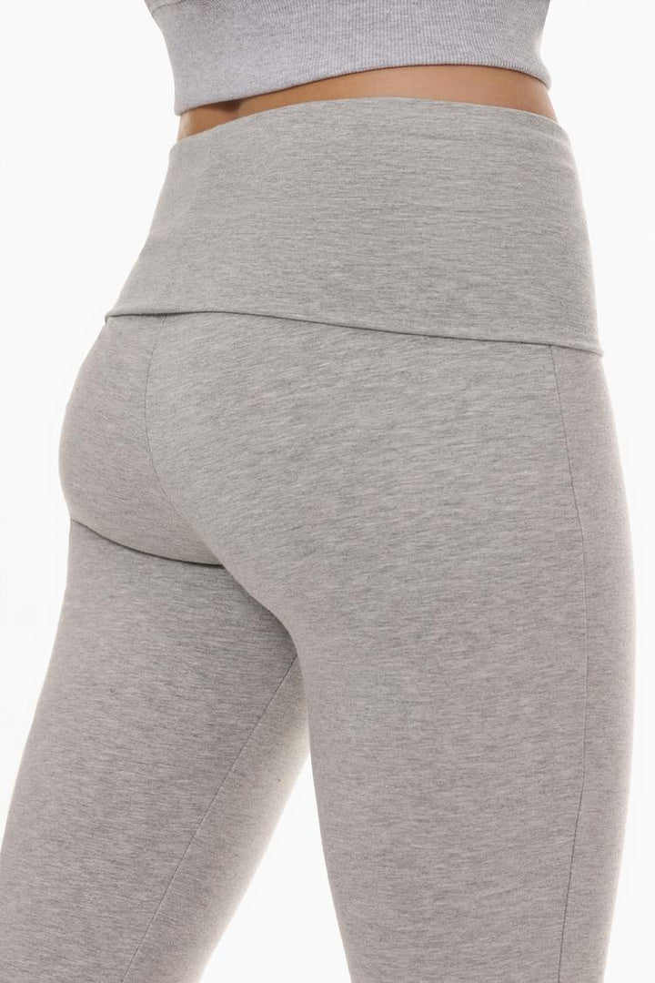 Back view of the grey leggings, showcasing the seamless design and fold-over waist for a comfortable fit.