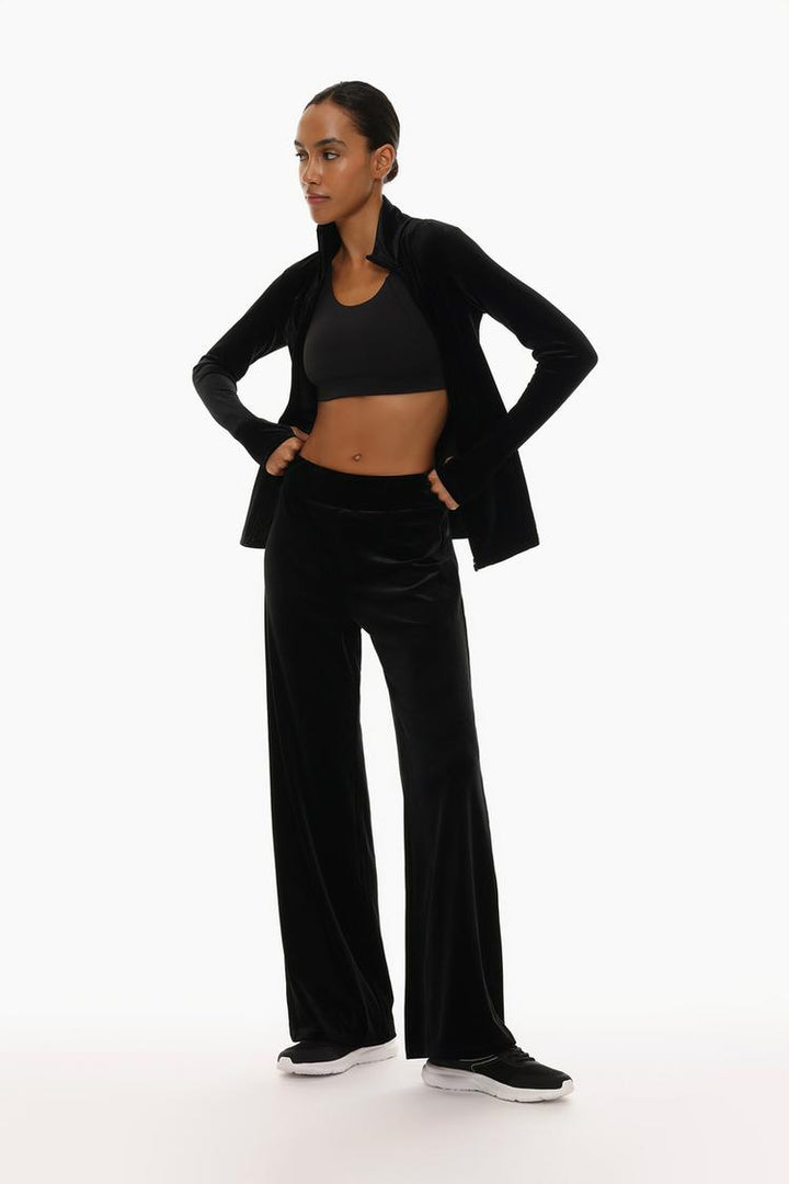 Front view of the black velvet leggings, showcasing the plush texture and relaxed fit.