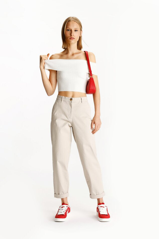 Full-body image of beige chino trousers, styled with a casual or semi-formal outfit, emphasizing their comfortable fit and versatile look.