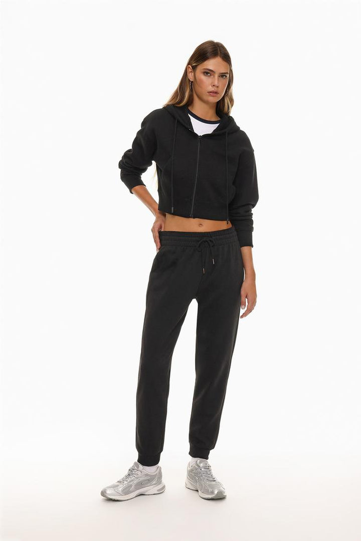 Full-body view of a women's black cropped jacket, showcasing its cropped length, sleek design, and relaxed fit, perfect for a stylish casual look.