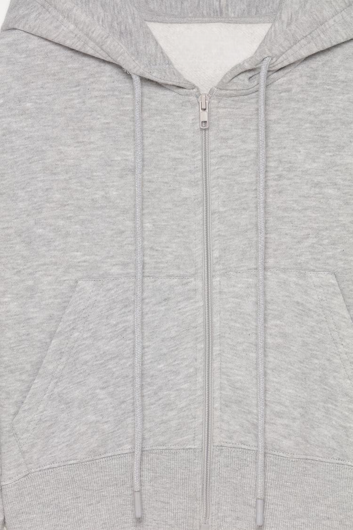 Zoomed-in view of a women's grey cropped jacket, showcasing the fabric texture, stitching details, and sleek cropped design.