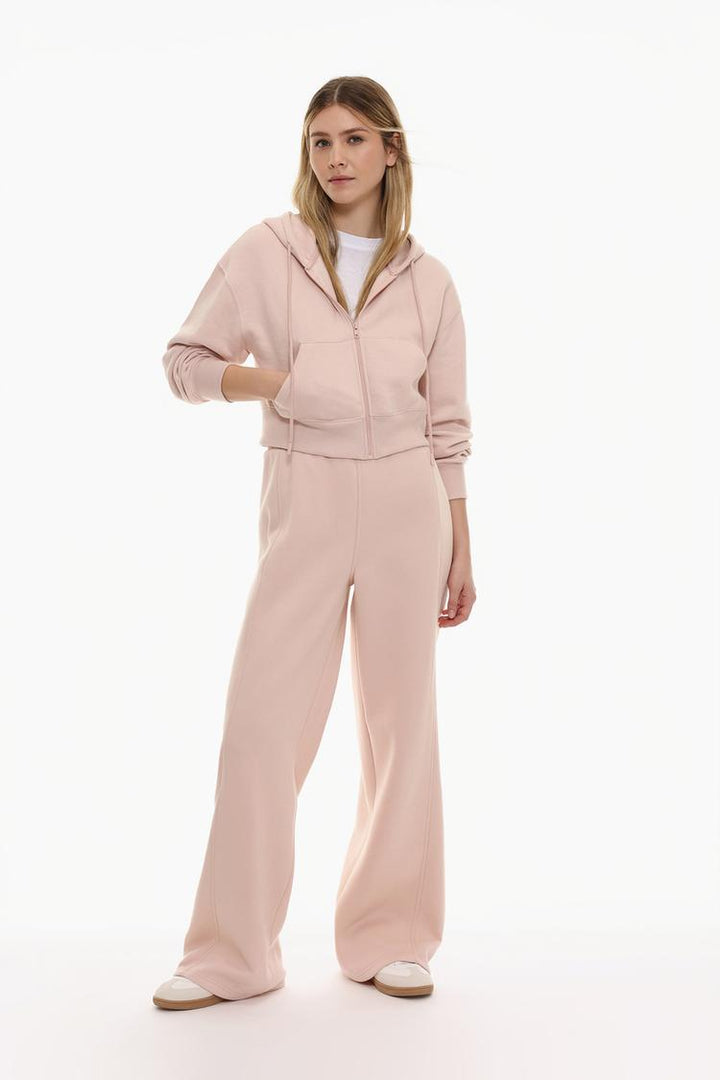 Full-body view of a women's pink cropped jacket, showcasing its modern design, cropped length, and stylish fit for a casual and trendy look.