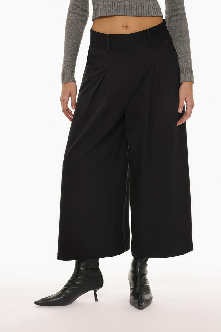 Front view of black culottes, showcasing the pleated detailing and relaxed fit