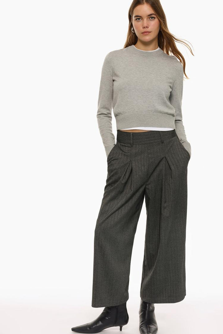 Grey culottes modeled to highlight their tailored fit and high-waist design