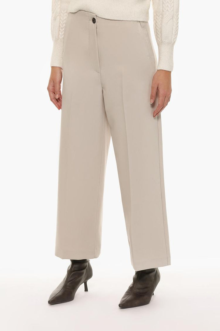 Front view of beige culottes without a waistband, featuring a clean and sophisticated silhouette.