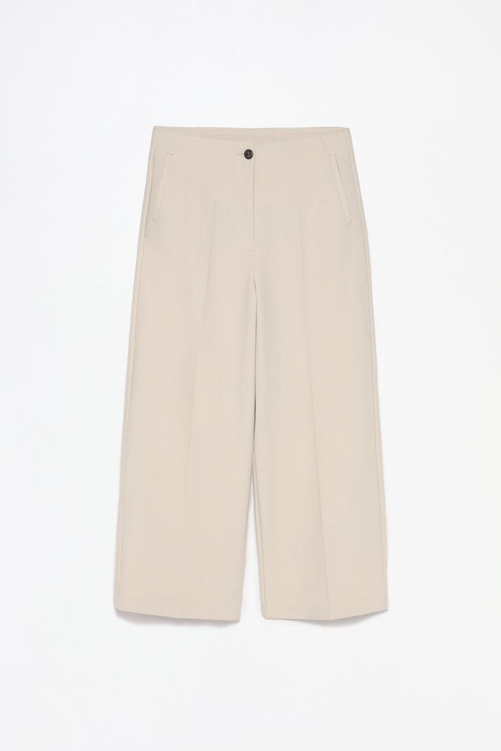 Full-product shot of beige culottes without a waistband, perfect for versatile wardrobe additions.