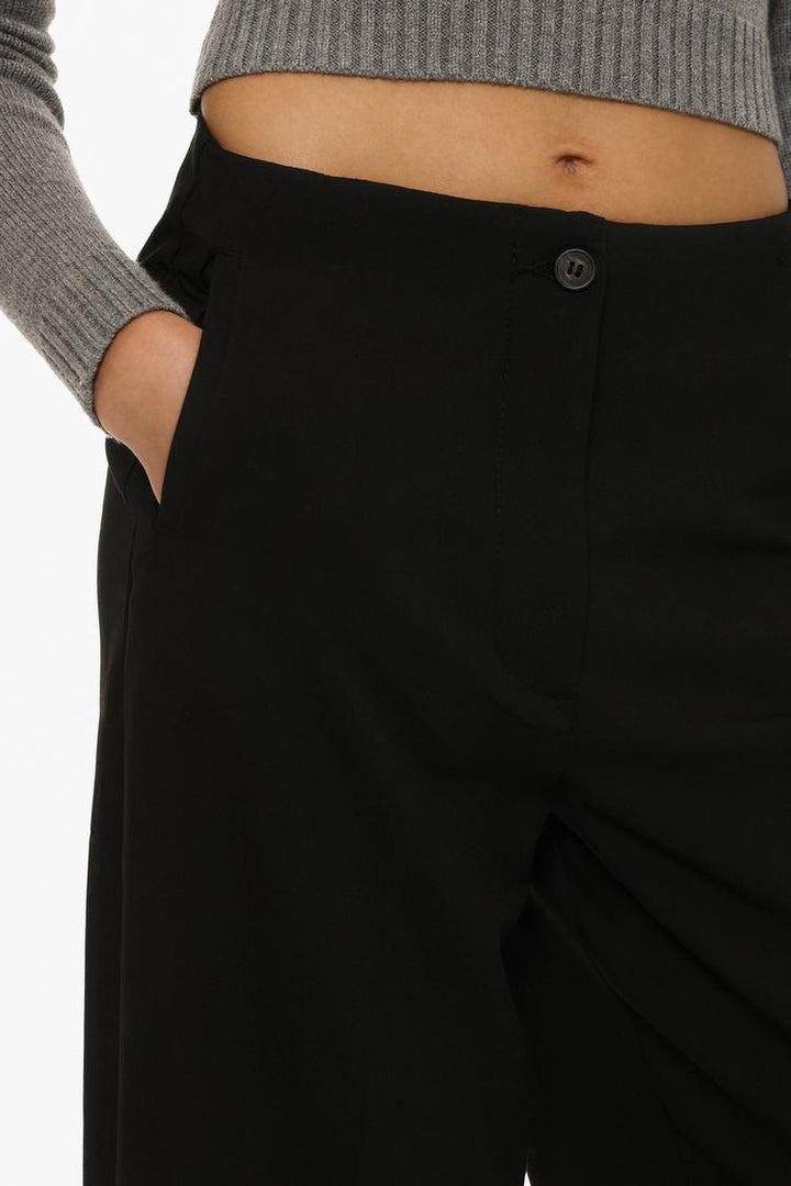 Full-body product shot of black culottes without a waistband, styled for effortless sophistication.