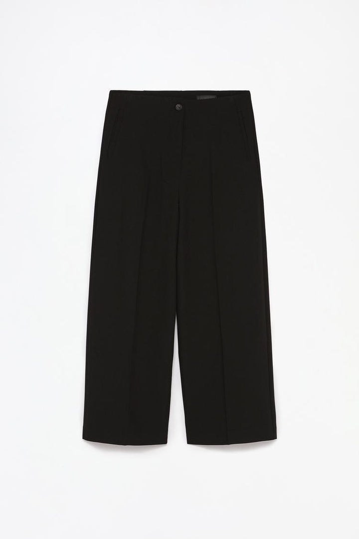 Full-product image of black culottes, emphasizing their timeless versatility and chic fabric.