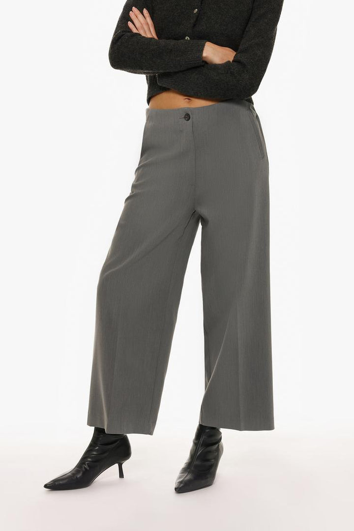 Front view of grey culottes without a waistband, presenting a relaxed yet polished look.