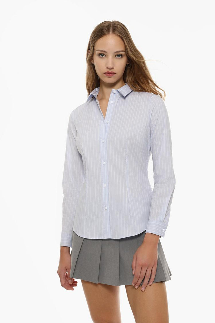 Close-up view of a fitted shirt, emphasizing its tailored silhouette, sharp collar, and sleek buttons for a refined, polished look.