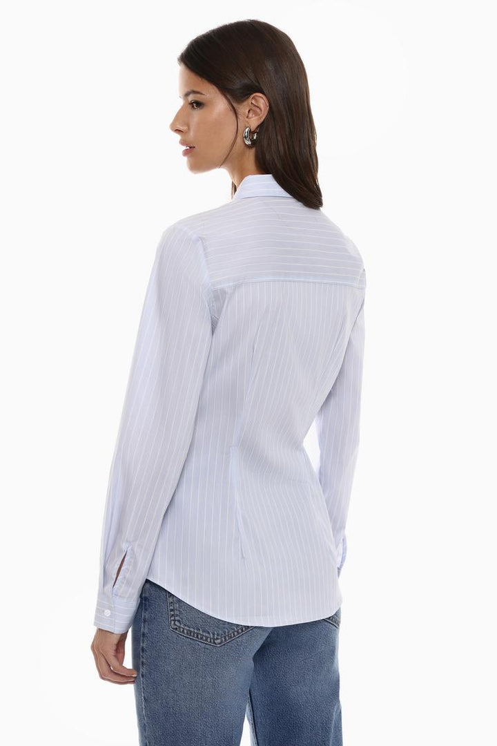 Side view of a fitted shirt, showcasing its slim silhouette, smooth lines, and contoured fit along the body for a modern, streamlined look.