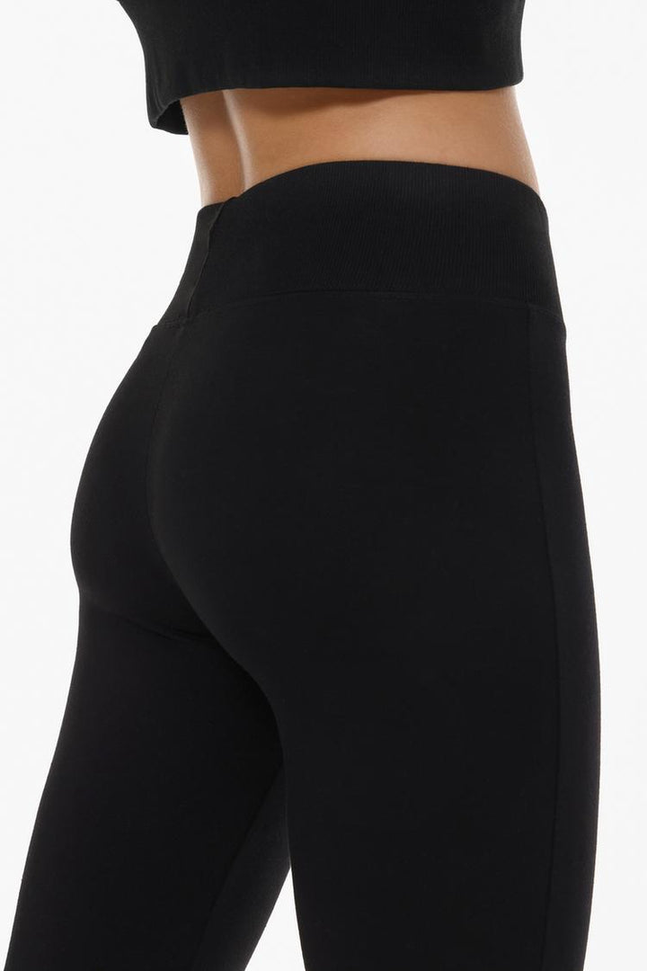 Back view of the black flared leggings, showcasing the seamless design and flattering fit from behind.