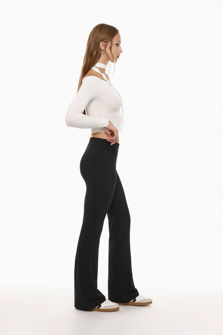 Close-up shot emphasizing the ribbed waistband detail and the soft, stretchy fabric of the black leggings.