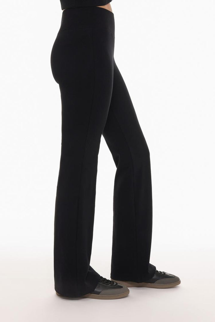 Back view of the black flared leggings, showcasing the seamless design and flattering fit from behind.