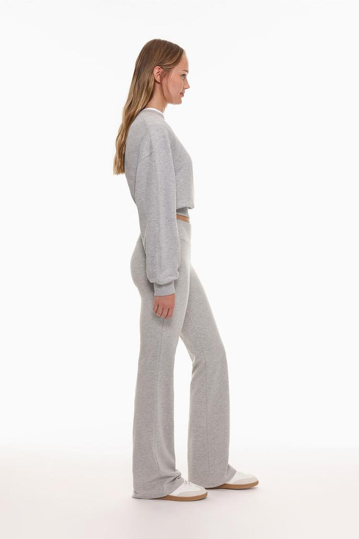 Side view of the grey flared leggings, showcasing the flattering fit and ribbed waist that adds a unique touch.