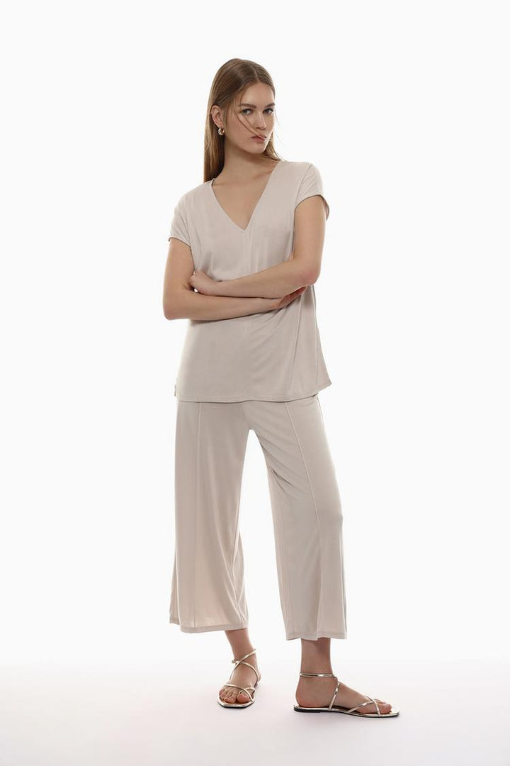 A versatile pair of flowing culottes in beige, designed with an elegant, relaxed fit.