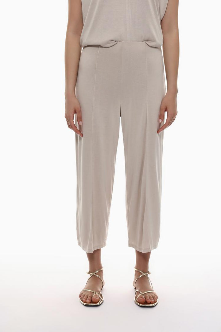 Front view of the beige flowing culottes, highlighting the waistline and flowing fabric.