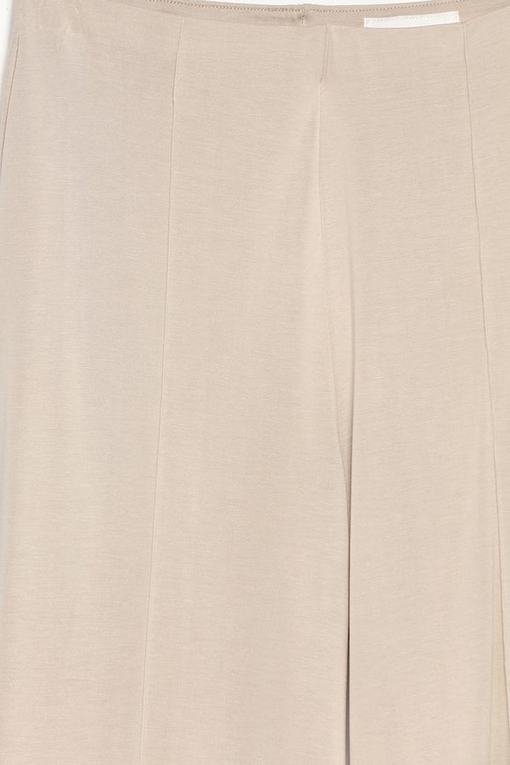 Detailed product image of the beige flowing culottes, focusing on the fabric and craftsmanship.