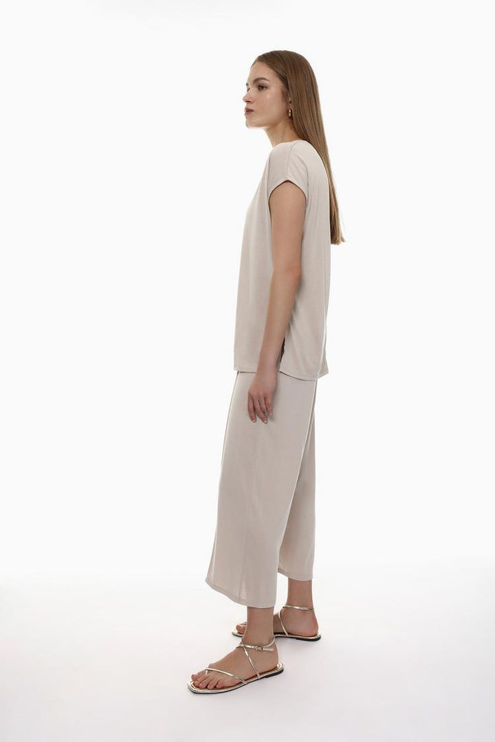 Side view of the beige flowing culottes, emphasizing the flow and flattering cut.