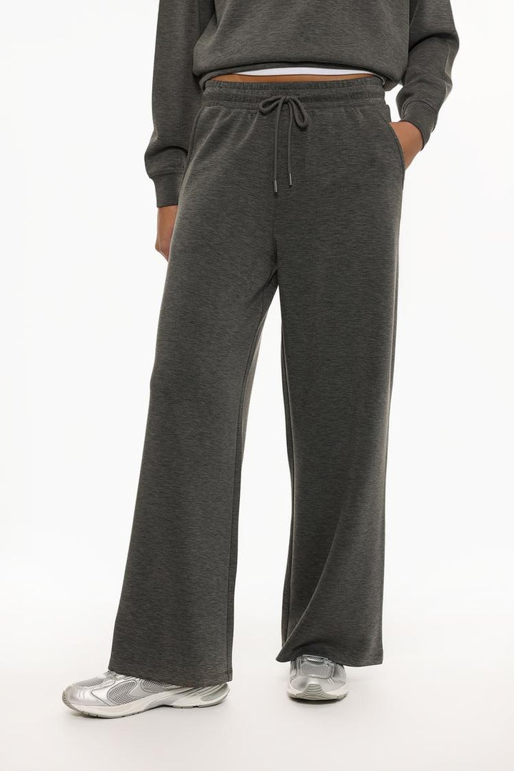 Grey flowing sports trousers with a modern and comfortable design.