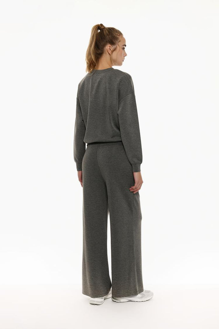 Back view of grey flowing sports trousers featuring a tailored sporty look.