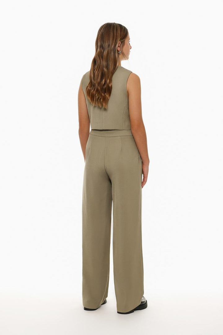 Full-body display of beige formal wide-leg trousers, styled for a contemporary wardrobe