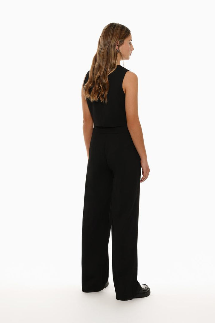 Back view of black formal wide-leg trousers, highlighting their tailored design and fit