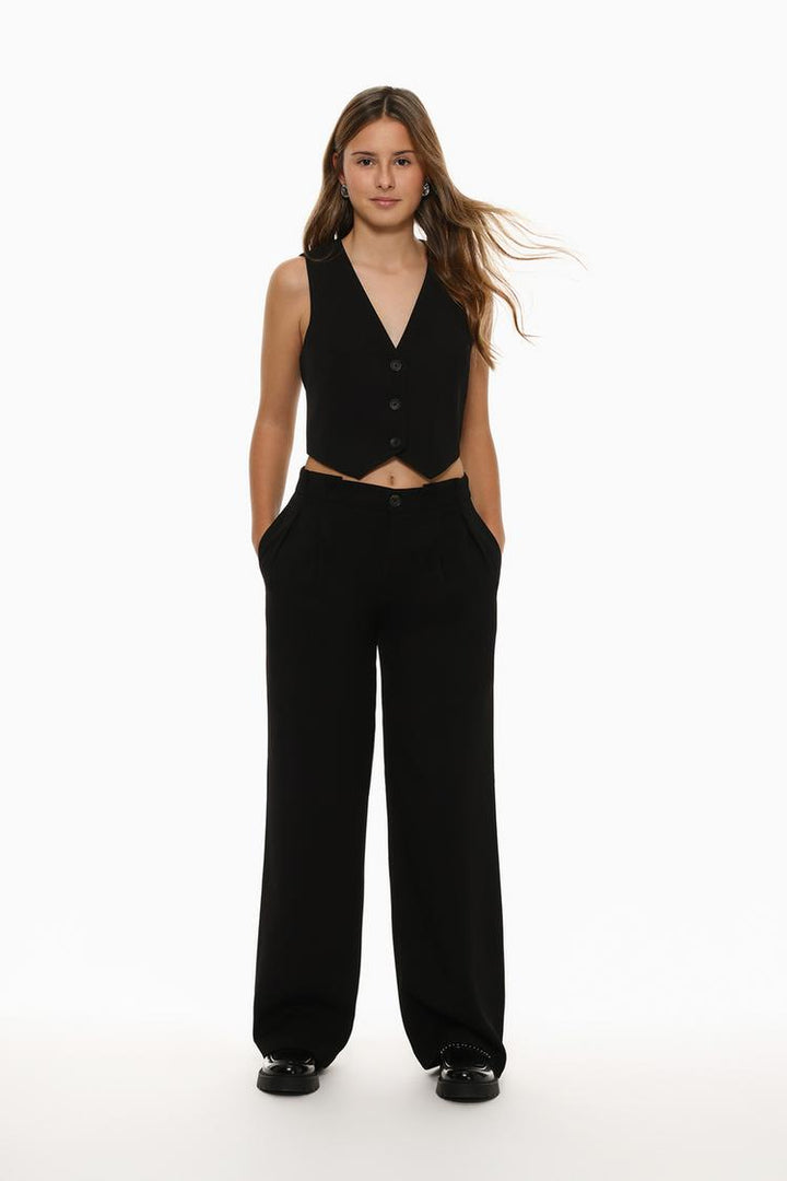 Full-body view of black formal wide-leg trousers styled for modern sophistication