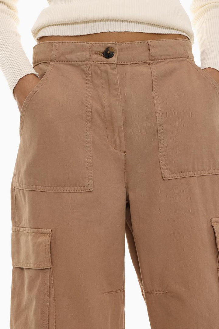 Rich brown garment-dyed cargo trousers designed with a rugged yet stylish aesthetic.