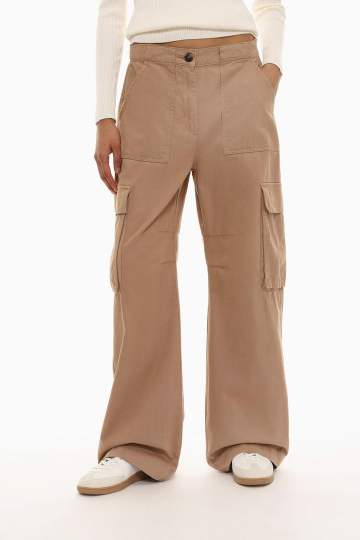 Front view of the brown trousers, with a focus on their functional yet minimalist design.