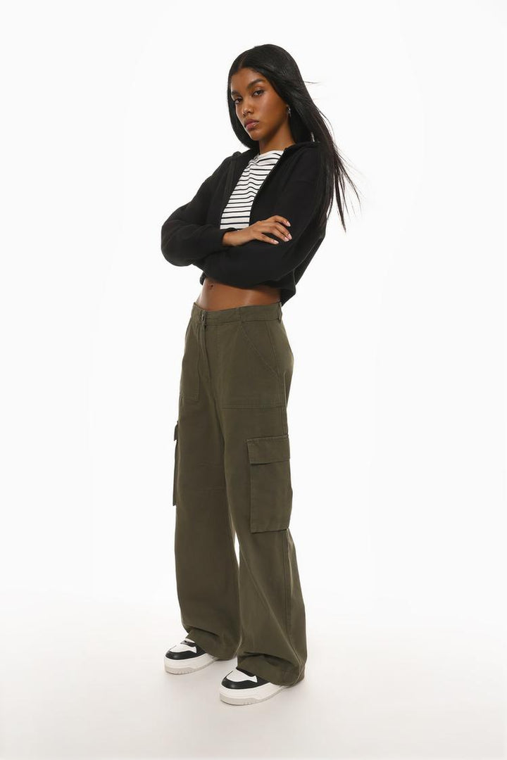 Complete product image of the dark green cargo trousers, focusing on their durable construction and aesthetic appeal.