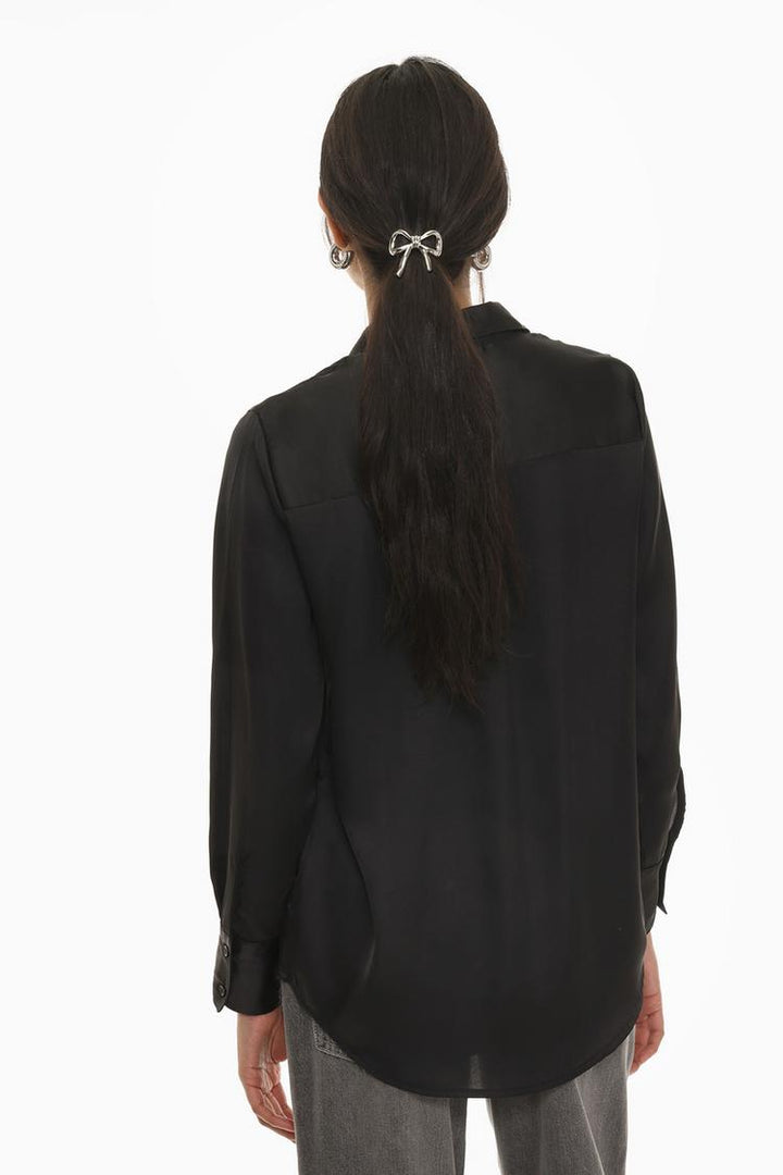 A back view of the black long-sleeve satin shirt, displaying its clean and polished silhouette. The smooth satin fabric enhances the shirt's refined style, with a tailored fit that provides a sophisticated and modern look.